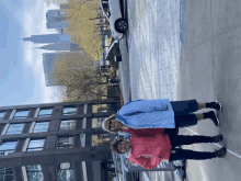 two women standing on a sidewalk in front of a building that says ' chase bank '