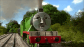 a green train with an angry face on the front