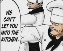 two men in chef hats are standing next to each other and one of them is talking to the other .