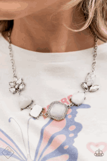 a woman wearing a paparazzi necklace with white beads