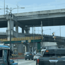 a busy highway with a davies sign on the bridge