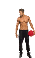 a shirtless man holding a red ball in his hand