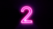 a neon sign of the number two is glowing on a black background .