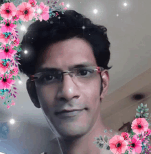 a man wearing glasses is surrounded by pink flowers and stars