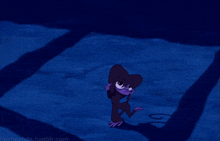 a purple monkey is hanging upside down on a blue surface