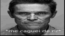 a black and white photo of a man 's face with the words `` me caguei de rir '' written below him .