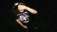 a blurry picture of a person wearing a t-shirt with a skull on it