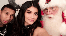 a man and a woman posing for a picture with santa claus