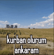 a sign that says kurban olurum ankaram is in front of a field