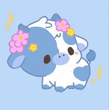 a blue and white cow with pink flowers on its head is sitting on a blue background .