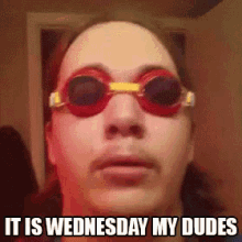 a man wearing red goggles with the words it is wednesday my dudes below him