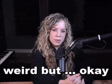 a woman sitting in front of a microphone with the words weird but okay written below her