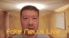 a man in a room with fake news live written on the screen