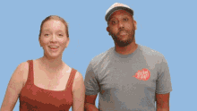 a man and a woman are standing in front of a blue background with the words new year written above them