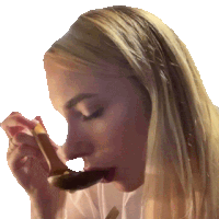 a woman is eating a piece of food with a spoon in her mouth