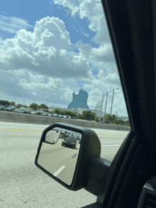 a car driving down a highway with a large guitar shaped building in the background