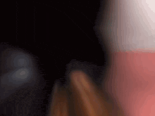 a blurry picture of a person 's face with a red and white background