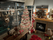 a christmas tree is lit up in a living room with a fireplace