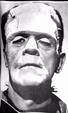 a close up of frankenstein 's face with a black shirt on