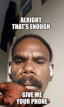 a man with a mustache holds his hand to his mouth and says alright that 's enough