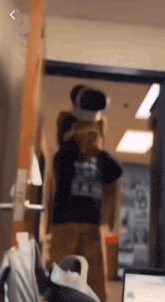 a person wearing a virtual reality headset in front of a laptop
