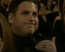 a man wearing a tuxedo and a ring on his finger
