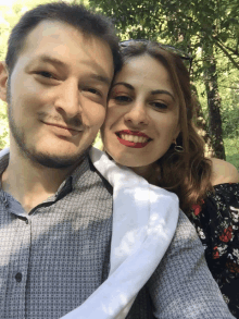 a man and a woman are posing for a picture together