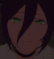 a close up of a person 's face with green eyes and a choker around their neck .