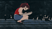 a girl in a red tank top sits on a roof reading a book