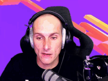 a bald man wearing headphones and a microphone