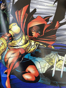 a comic book character with a red cape and gold armor