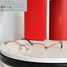 a pair of cartier glasses sitting on a table next to a red box