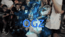 a blurry photo of a group of people with ogz written in blue