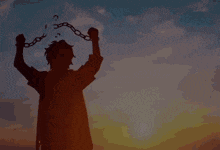 a silhouette of a person with chains around their neck