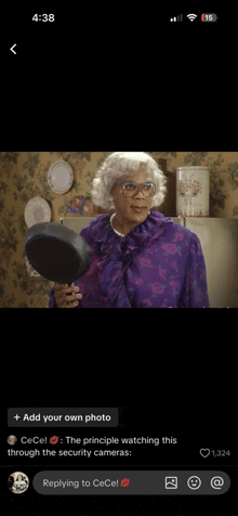 a phone screen shows a picture of a woman in a purple dress holding a pan