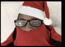 a person wearing glasses and a santa hat is covering their face