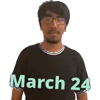 a man wearing glasses and a black shirt says march 24