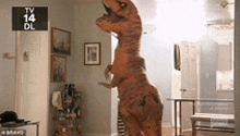 a person in a t-rex costume is standing in a room