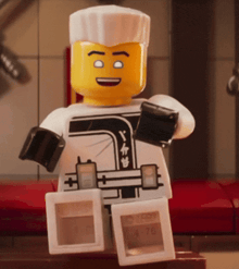 a lego figure is holding a box that says ' ninjago ' on it