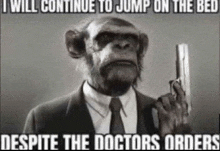 a chimpanzee in a suit and tie is holding a gun in his hand .