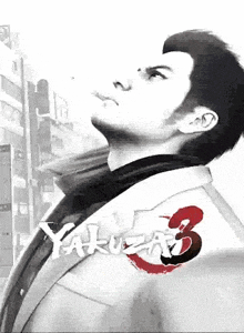 a man in a suit and tie is standing in front of a building with the word yakuza 3 written on it .