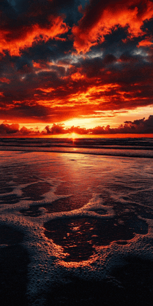 a sunset over a body of water with a red sky