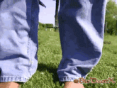 a person wearing blue jeans is standing in the grass with bio duschx written below them