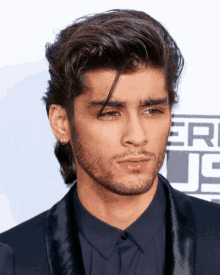 a close up of a man 's face in front of an american music awards logo