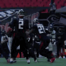 a group of football players are running on a field with a sign that says 40 in the background .