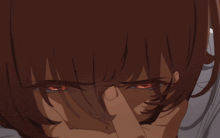 a close up of a person with red eyes covering their face
