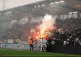 a group of soccer players are celebrating a goal in front of a banner that says ' sven koffer ' on it