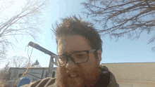 a man with glasses and a beard stands in front of a rv