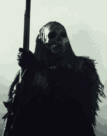 a black and white photo of a grim reaper holding a spear