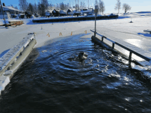 a person is swimming in a body of water with the letter a visible